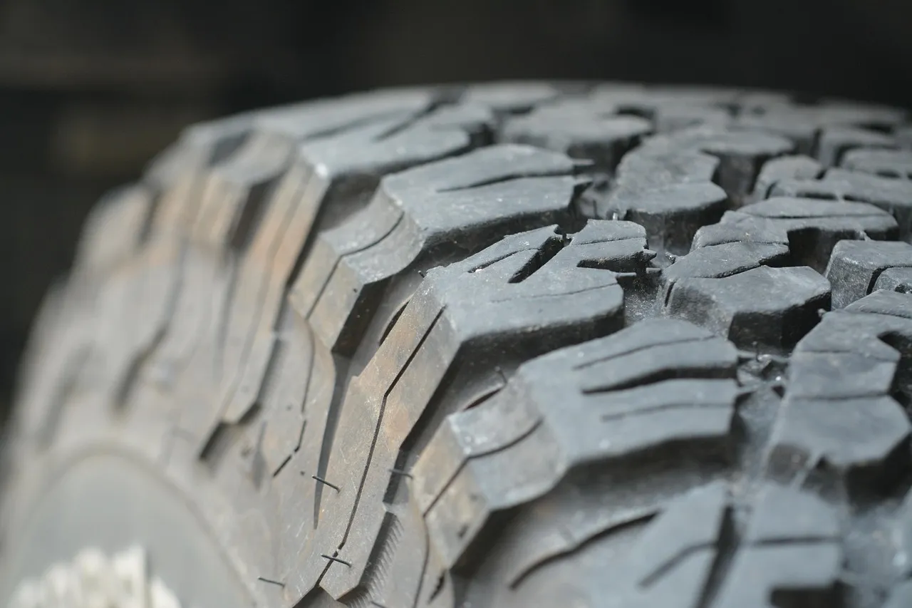 Close-up of a deep, chunky tyre tread with small sipes cut into each block